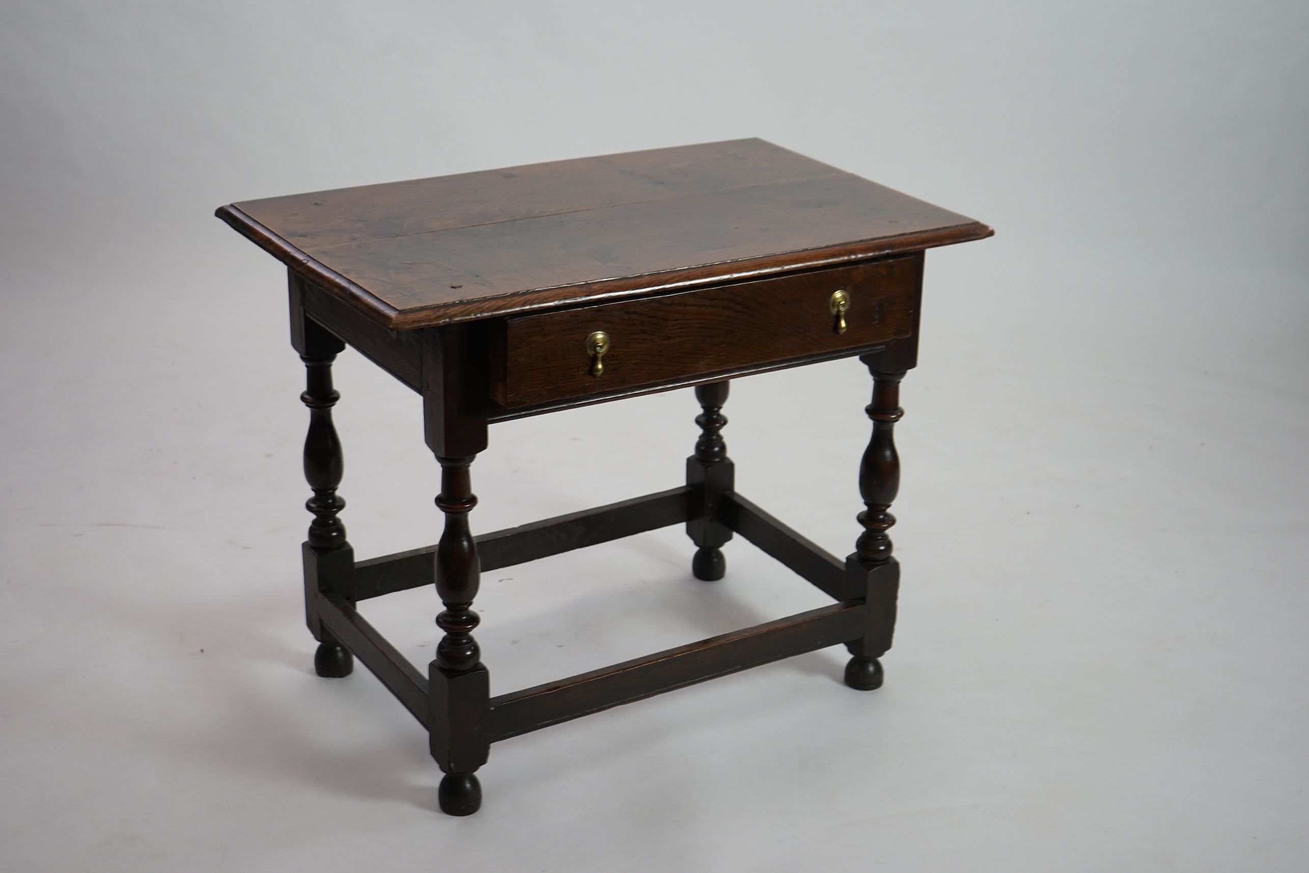 An early 18th century and later oak side table